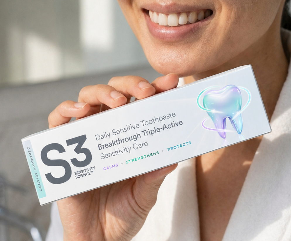 A hand holding the S3 Daily Sensitive Toothpaste pack.
