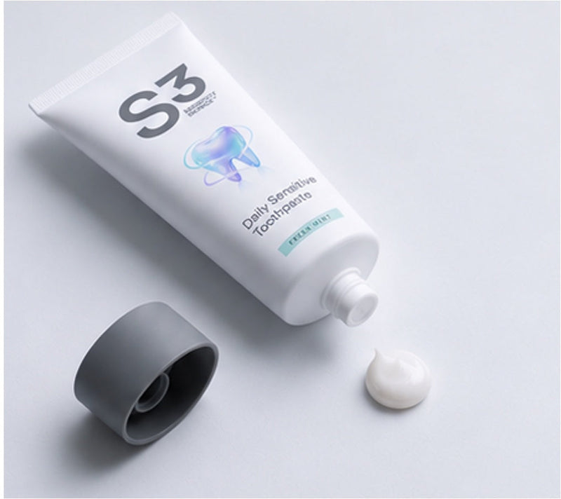An open tube of S3 Daily Sensitive Toothpaste lying flat beside its cap and a small dab of paste